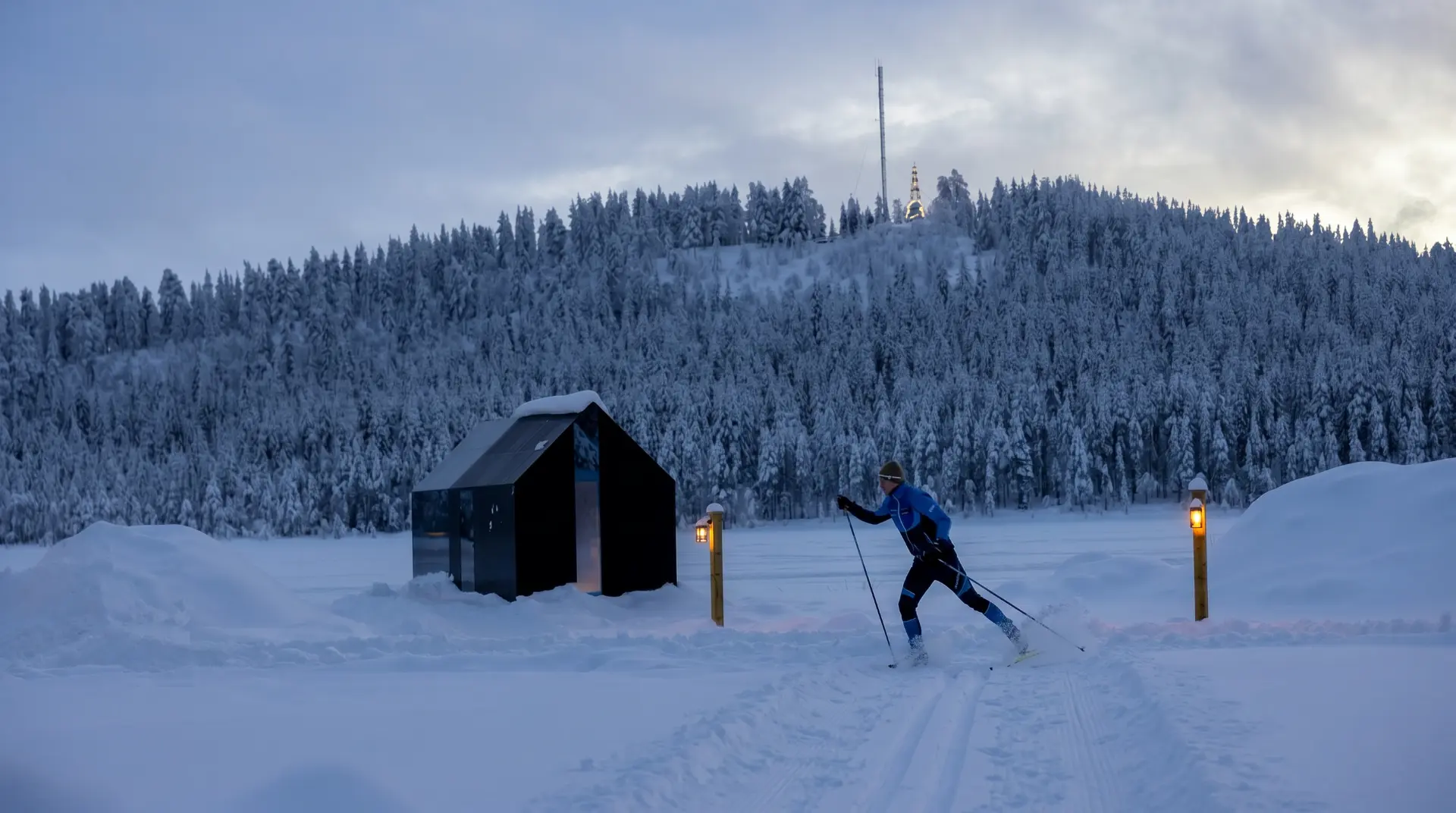 Backcountry skier climbing an untouched snowfield in the Lapland mountains.